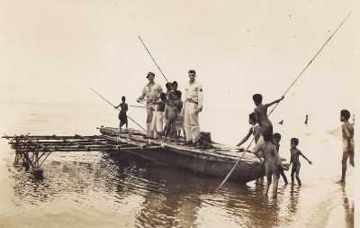 large outrigger canoe, with long poles