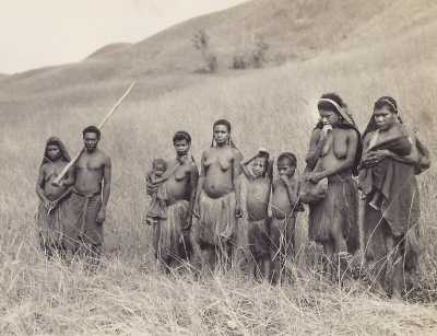 Papuan family on grassy hillside