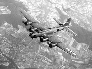B-17 flying over town and farmland
