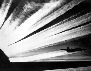 B-17  silhouetted against contrails
