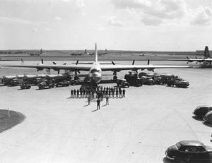 B-36, crew, and vehicles lined up for inspection