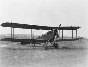 D.H.4 biplane on dirt airfield