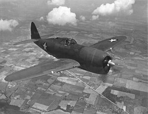P-47 Thunderbolt flying low over farmland