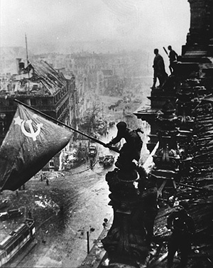 Soviet soldier raising flag over the Reichstag